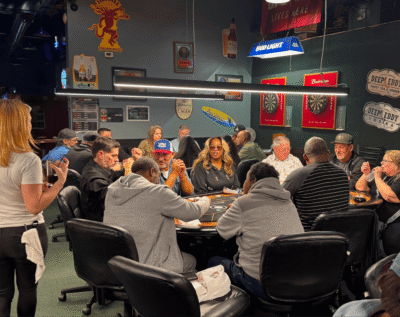 People enjoying a lively game night at a bar with a snacks and drinks.