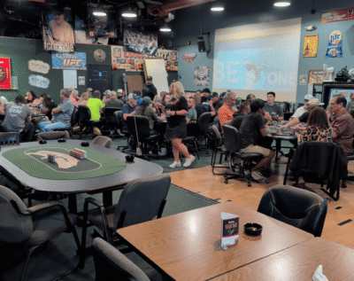 A lively group of people enjoying a social event in a cozy, a decorated room.